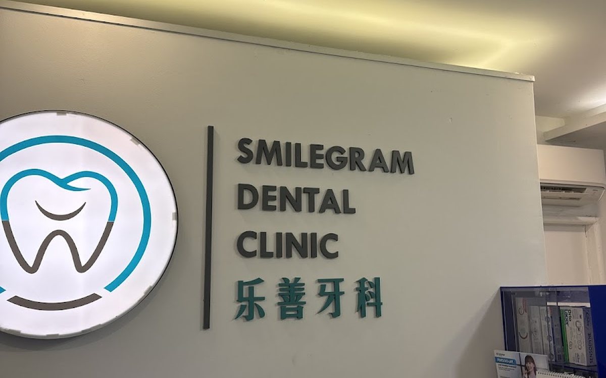 Reception and SmileGram logo wall at the Seksyen 14 clinic